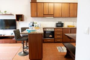a kitchen with wooden cabinets and a counter top at Furnas Panorama House in Furnas