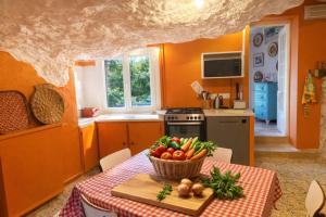 a kitchen with a table with a bowl of vegetables on it at Les rives enchantées in Loches