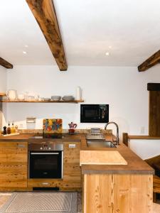 a kitchen with wooden cabinets and a counter top at Appartamento LA ROSA in Ponto Valentino +20 photos