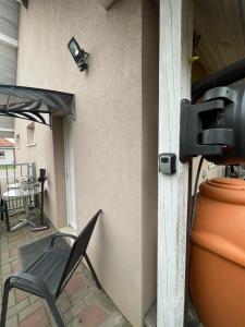 a patio with a chair and an umbrella and a camera at Apartmán Mašovice u Znojma in Mašovice