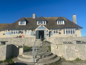 a large stone building with stairs leading to the door at Apartment 2 Maritime House in Portland