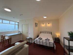 a bedroom with a bed and a table and a couch at Apartment 2 Maritime House in Portland