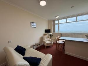 a living room with a white couch and a table at Apartment 2 Maritime House in Portland