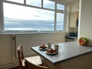 a kitchen with a table with two plates of food on it at Apartment 2 Maritime House in Portland