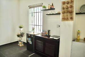 a kitchen with a counter and a window at OThuy's House in Hue in Hue