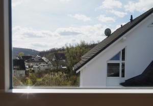 a view from a window of a white house at Ferienwohnung in der Region Warstein in Warstein