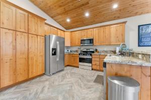 a kitchen with wooden cabinets and a stainless steel refrigerator at The Speckled Gem in Kings Beach