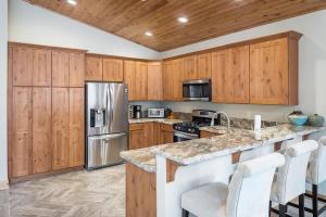 a kitchen with wooden cabinets and a stainless steel refrigerator at The Speckled Gem in Kings Beach