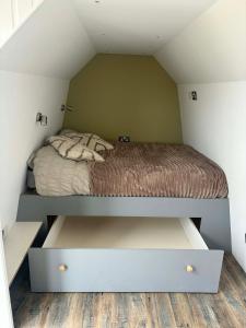 a bed in a small room in a attic at The Orkney Pod in Stromness