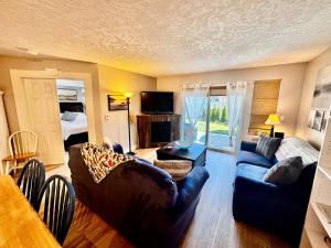 a living room with a couch and a table at Lakefront Condo and Beach in Shawnigan Lake
