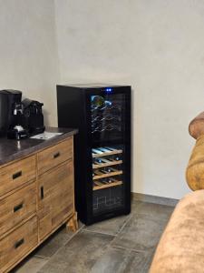 a black refrigerator freezer sitting in a kitchen next to a counter at L'EMPREINTE in Salavas