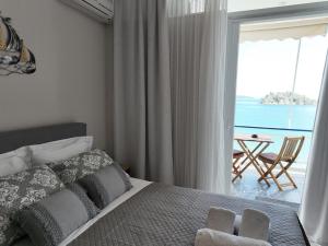 a bedroom with a bed and a view of the ocean at Captain's Tolo Sea View 2 in Tolo