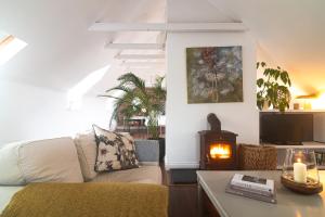 a living room with a couch and a wood stove at Courtyard Cottages in Tralee