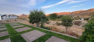 an image of a yard with grass and trees at Achab chalets in Usakos