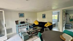 a living room with a couch and a table at Le Lodge du Touquet in Le Touquet-Paris-Plage