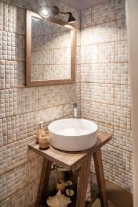 a bathroom with a white sink and a mirror at Oliva Mare II in Agia Fotia +11 photos