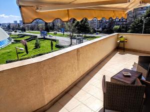 a balcony with a table and a view of a city at Trend Apart in Burgas