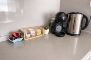a kitchen counter with a coffee pot and a coffeemaker at Guest Apart Arda in Kŭrdzhali