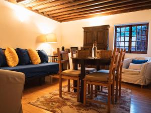 a living room with a table and a blue couch at Quinta de Segade in Santa Marta