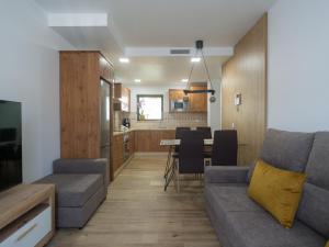 a living room and kitchen with a couch and a table at Aguadulce Agaete 1A in Agaete