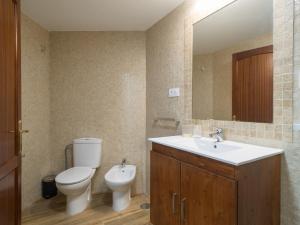 a bathroom with a toilet and a sink and a mirror at Aguadulce Agaete 1A in Agaete +38 photos