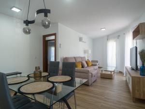 a living room with a table and a couch at Aguadulce Agaete 1B in Agaete