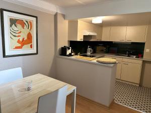 a kitchen with a table and a counter top at studio Bevaix in Bevaix
