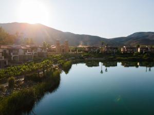 an aerial view of a town with a river at El Cielo Resort in Valle de Guadalupe