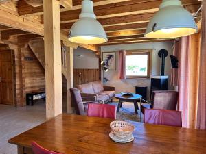 a living room with a wooden table and chairs at Au bord du lac IV in Montigny-en-Morvan