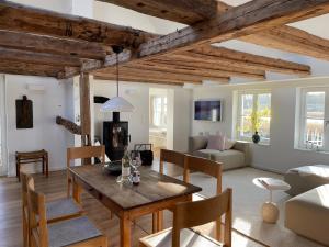 a living room with a wooden table and chairs at Seedorf Hideaway, Reethaus mit Garten und Privatsteg, Kamin, Sauna und Hot Tub in Ostseebad Sellin