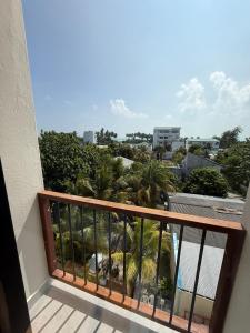 a balcony with a view of palm trees at Ruka Maldives in Dhiffushi