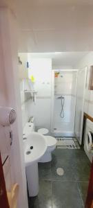 a white bathroom with a sink and a toilet at Casa La Barria in Nueva de Llanes +58 photos