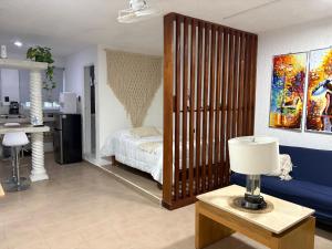 a bedroom with a bed and a table with a lamp at Majen Nah in Progreso