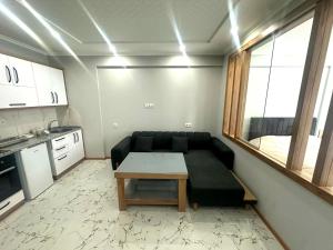 a living room with a couch and a table at Ande Tower studio in Minda
