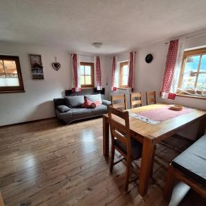 a living room with a table and a couch at Haus Elfriede in Schwendau