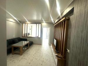a living room with a couch and a table at Ande Tower studio in Minda
