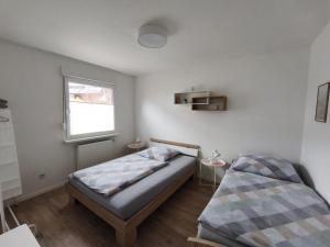 a bedroom with a bed and a window at Ferienwohnung Blick Rappenstein in Hausen am Tann