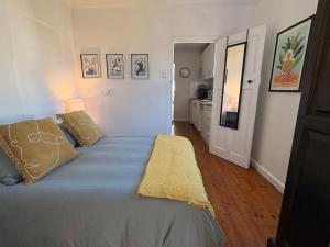 a bedroom with a bed with blue sheets and pillows at Cosy Coastal Hideaway in Hermanus