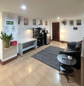 a living room with a couch and a table at PRO Guest House in Thong Sala
