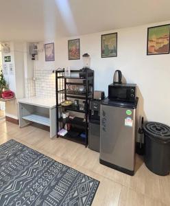 a kitchen with a refrigerator and a table in a room at PRO Guest House in Thong Sala +11 photos