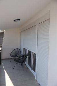 a balcony with a table and a window with blinds at Apartman SASHA in Bar