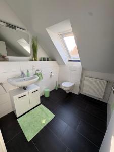 a bathroom with a sink and a toilet at Apartments Reischl in Bergkirchen +86 photos