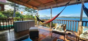 a hammock on a deck with a view of the water at SEGUNDA BRISA in Tucker Bight