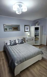 a bedroom with a large bed and a mirror at Apartment GLAMOUR Downtown balcony FREE PARKING SPACE in Krakow