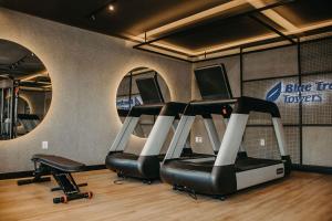 a gym with five cardio machines in a room at Blue Tree Towers Jaguariúna in Jaguariúna