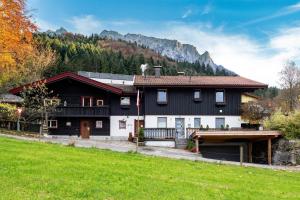 a black and white house with a mountain in the background at Charming Mobile Home Retreat in Ebbs, Austria - Tranquil Escape in Ebbs