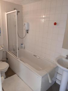 a bathroom with a tub and a toilet and a sink at Heskin Farm in Burscough +23 photos