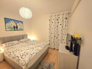 a bedroom with a bed and a vase of flowers at Apartma Katarina's place in Bovec