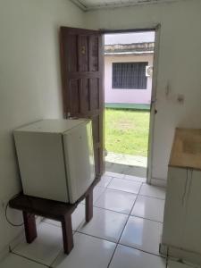 a refrigerator in a room with an open door at Guardião in Porto Velho