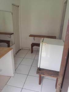 a room with a table and a refrigerator at Guardião in Porto Velho